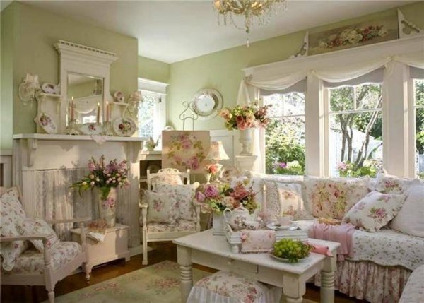 shabby-chic-style-living-room-with-sage-green-wall-and-floral-covers-and-vases-and-vintage-coffee-table-and-mirror-over-mantel másolata