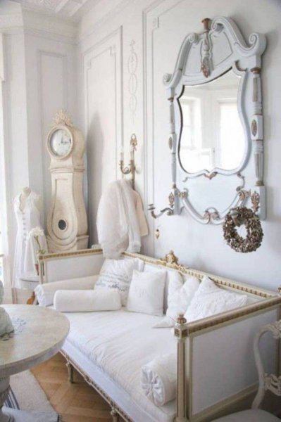 shabby-chic-style-living-room-with-vintage-clock-and-mirror-and-round-table-and-adorable-seating-with-pillows